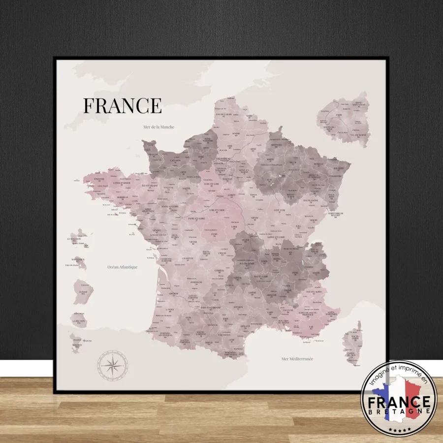 Carte de France au style aquarelle rose Denise posée contre un mur sur un sol en bois