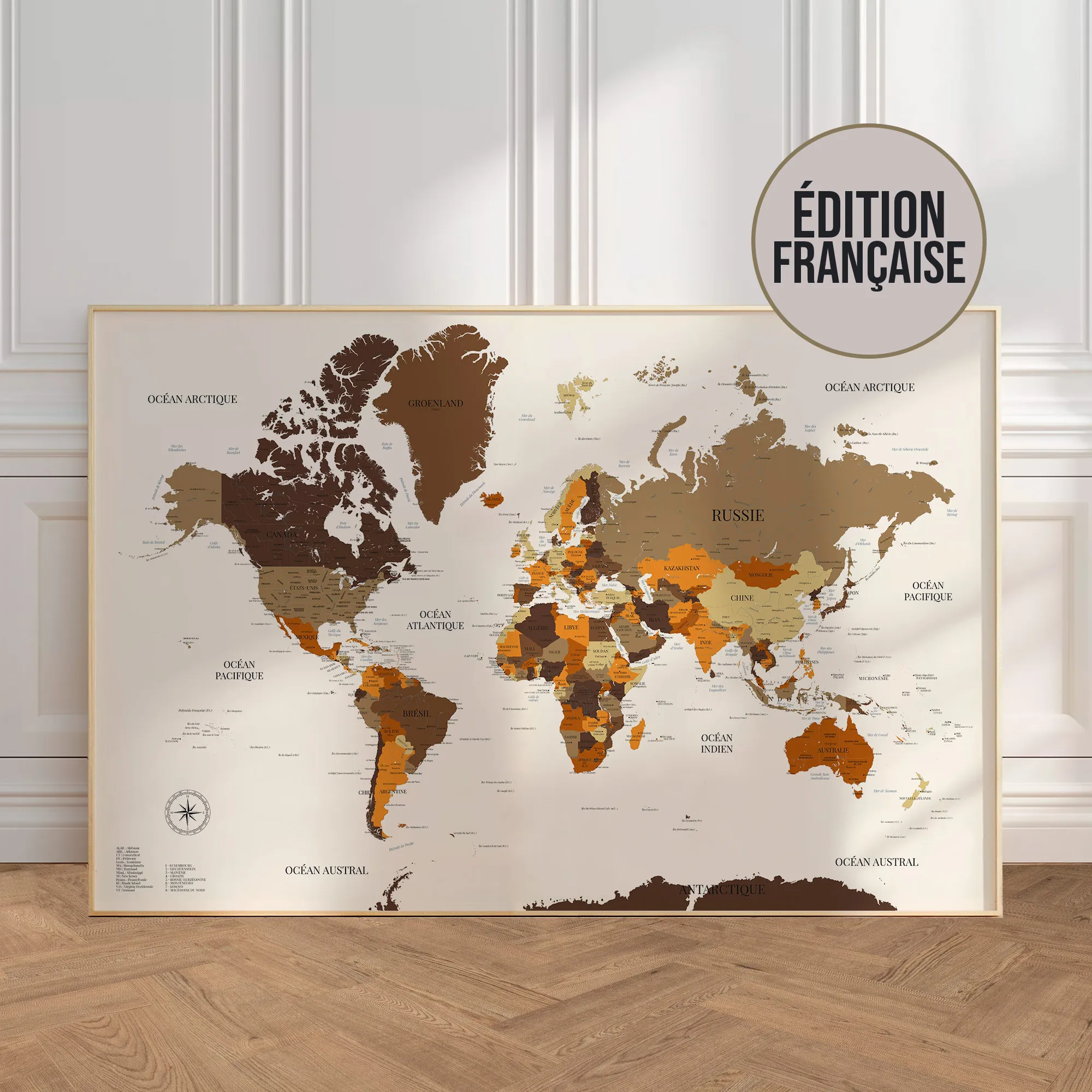 Carte du monde murale en français encadrée et posée contre un mur